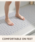 Big Time Grip Non Slip Bathtub Shower Mat Features Heavy Duty Suction Cups For Zero Slip Drains Quick Dry Cutouts Made From Soft Bendable Tpe For Super Chill Foot Comfort And Hassle Free Rinse Clear Thirty Five By Sixteen Inch Layout with feet standing on it