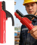 Heavy Duty 300A Copper Welding Electrode Holder With PVC Rubber Insulation Handle held by worker, showing red body and black grip.