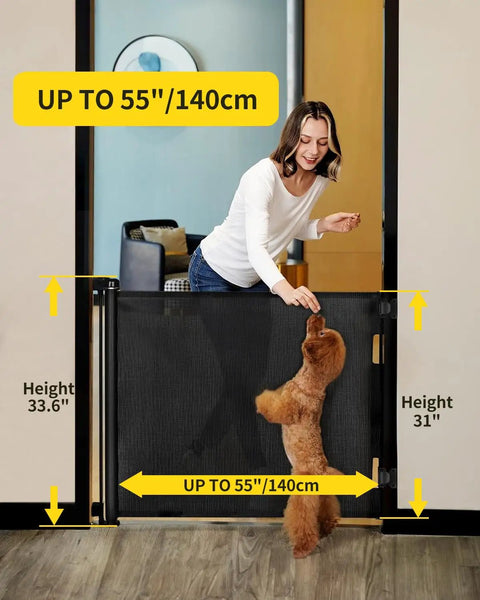 Woman using Retractable Mesh Baby Gate For Doorways, Stairs, And Hallways, 33 Inch Tall, Expands Up To 55 Inches Wide with dog