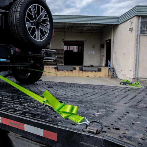 Heavy Duty Axle Tie Down Kit Featuring Hella Bright Neon Green 2 Inch Webbing And Reliable Wire J Hook Ratchet Straps for secure hauling.