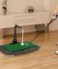 Adjustable Golf Swing And Hitting Trainer Ball Return Practice Tool in use, showing green mat and ball setup indoors.