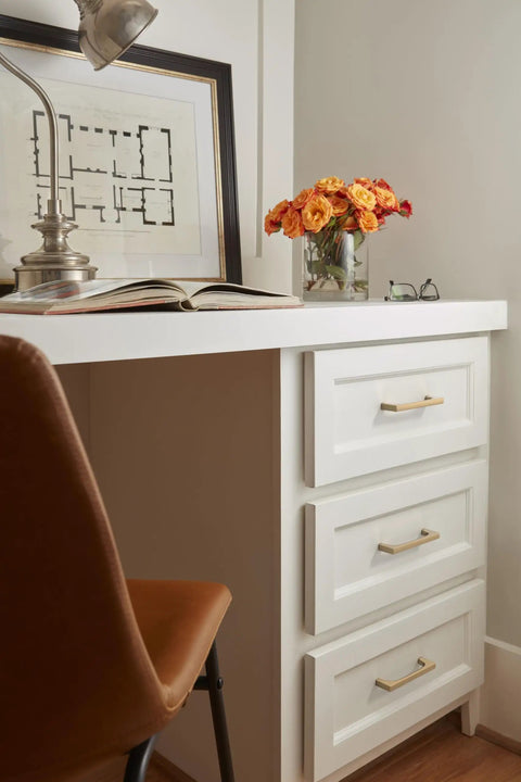 Super Sleek Contemporary Cabinet Drawer Pull With Champagne Bronze Finish And Killer Modern Hardware Design For Your Top Notch Kitchen Upgrade Featuring Effortless Glide Mechanism And 5 1/16 Inch Center To Center Mounting Spacing on white drawers.