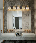 Five Light Black Modern Crystal Vanity Wall Lamp above bathroom mirror in sleek setting with crisp ambience and grey marble walls.