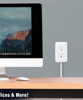 Presto Plug Outlet Extender With Built In Shelf, 4 Foot Cord mounted next to a computer on a desk in an office setting.