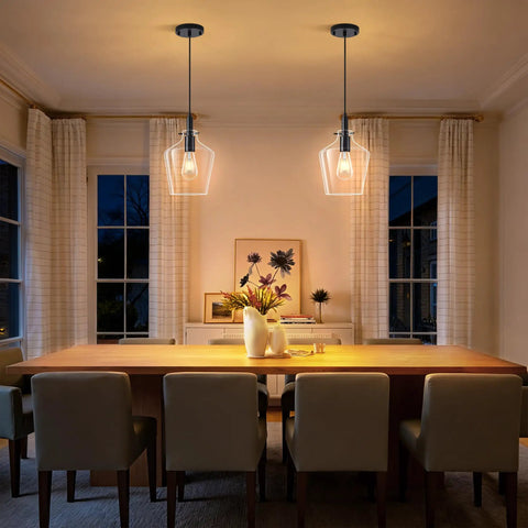Kveosv 2 Pack Kitchen Island Pendant Lights, 8" Clear Glass Shade over dining table in modern setting, black metal fixtures.
