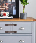 ABS Material Cabinet Locks 4 Pack For Cupboards And Drawers No Sweat Easy Peel And Stick Safety Straps on a gray dresser
