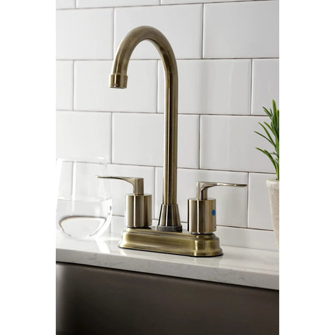 Serena Two Handle Deck Mount Bar Faucet in antique brass on white countertop, features two hole four inch centerset, washerless cartridge.