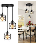 Slick Farmhouse Three Light Pendant With Adjustable Drop Cords Matte Black Hanging Ceiling Lamp above dining table with chairs.