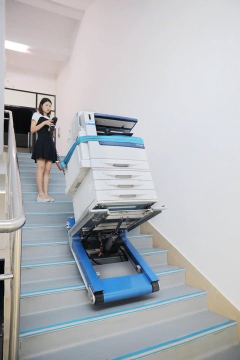 Heavy Duty Electric Stair Climbing Hand Truck With Dual Motors And Smart Load Balancing Board handles a copier going up stairs.