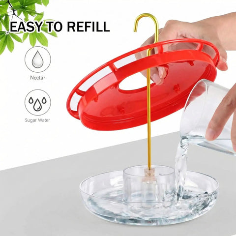 Two Pack 16 Oz Hummingbird Feeders Dish Style Leak Proof With Built In Ant Moat And Bee Proof Feeding Ports being refilled