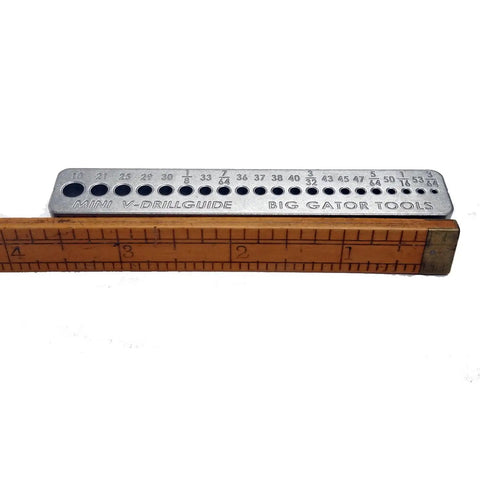 4 Piece Precision Drill Guide Set With SAE Hole Sizes And Numbered Holes, Durable Nickel Alloy Steel, beside a measuring ruler