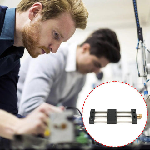 Built Tough Aluminum Manual Sliding Table Actuator on workbench with professionals for precision industrial tasks.