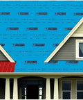 Heavy Duty Self Adhering Roof Underlayment 41 Mil Ice And Water Shield laid on a house roof with red panels.