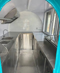 Interior view of Rollout Ready Custom Towable Food Trailer Commercial Mobile Catering Kitchen with stainless steel surfaces.