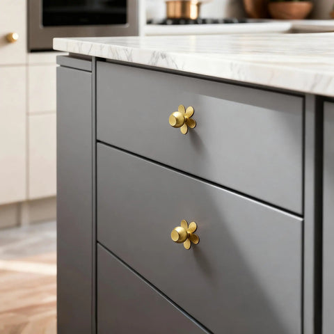 Real Deal Solid Brass Cabinet Knobs Slick Flower Backplate Brushed Gold Finish on gray drawer pull in kitchen setting.