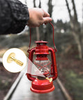 Front view of red lantern held by hand; inset shows brass-colored lamp switch knob replacement (4-pack)