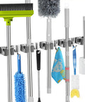 Front view of heavy duty wall mount mop and broom holder with five slots and four hooks, organizing cleaning tools, stainless steel.
