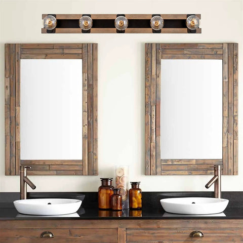 36-Inch Five-Light Modern Farmhouse Vanity Light with smoked birch wood grain and black finish above double mirrors in bathroom
