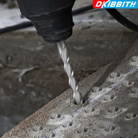 Close-up of carbide-tipped SDS Plus drill bit drilling into concrete block.