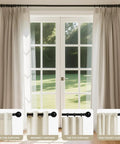 Heavy Duty Adjustable Curtain Rod Set 32 To 120 Inches 1 Inch Diameter Black Finish installed over patio doors with curtains