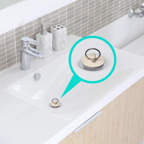 Four Pack Stainless Steel Sink Strainers With Rubber Stopper Plug Set Fits 2.125 Inch Top Diameter And 1 Inch Basket Ideal For Bathroom Utility Slop Laundry RV Lavatory Sinks installed in white bathroom sink.