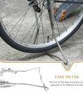 Adjustable Dual Leg Bike Kickstand With Non Slip Feet for Quick Release Tires supporting a bicycle on concrete surface.