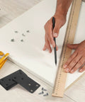 Person using ruler and pencil, stainless steel flat straight brackets with screw holes six pack on table, easy no welding install.