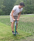 Man using Five In One Lawn And Garden Tool For Easy Planting And Weeding Bulb Planter Sod Plugger Weeder Annual Planter And Soil Tester