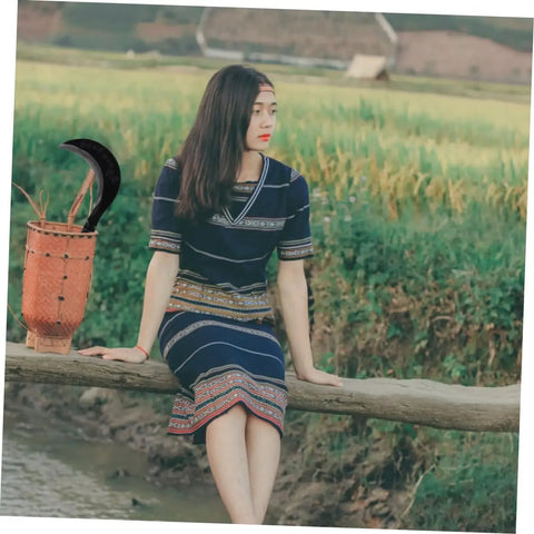 Long Handle Manganese Steel Scythe For Gardening And Weeding Tool with Comfortable Grip next to woman in traditional attire.