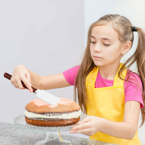Young girl using High Temp Silicone Spatulas Set Of 2 10 Inch Heat Resistant Nonstick Spatula Scrapers With Nylon Handles NSF Certified Kitchen Must Haves For Cooking And Baking to frost cake