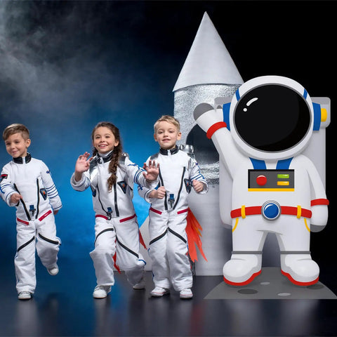 Children in astronaut costumes beside a 4.67 Ft Astronaut Cardboard Cutout For Space Party Stand Up Backdrop And Photo Prop.