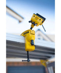 MaxSteel Multi Angle Hobby Vice With 360-Degree Ball Joint clamped on workbench, yellow and black design, outdoors