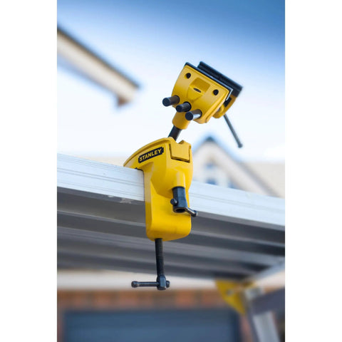 MaxSteel Multi Angle Hobby Vice With 360-Degree Ball Joint clamped on workbench, yellow and black design, outdoors