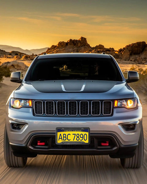 Front view of a car with Dope Carbon Fiber Look License Plate Frames 2 Pack Matte Black Aluminum Car Tag Holder against desert backdrop