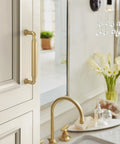 Coble Transitional Champagne Bronze Cabinet Pull 5-5/8 Inch Overall Length with 5-1/16 Inch Center-to-Center Mounted on Beige Cabinet