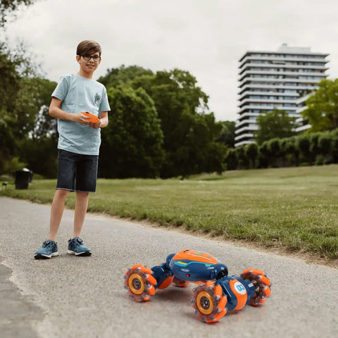 Child operating 4WD Gesture Control RC Stunt Car For Kids, Hand Sensing Remote Car With Lights And Music on outdoor path