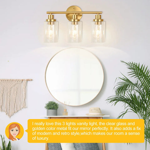 Brushed Brass 3 Light Vanity Wall Sconce With Clear Glass Shades, Modern Farmhouse Bathroom Fixture above round mirror
