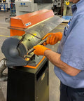 Kickass Dust Collection System For Eight Inch Angle Grinders featuring a worker grinding with sealed motor and air sweep.