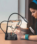 Person using Magnetic Helping Hands With Three LED Magnifying Lamp, Pro Soldering Station, Flexible Gooseneck Arms for electronics repair
