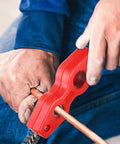 Red 4-in-1 copper pipe cleaner with wire brushes, side view on 1/2 in and 3/4 in copper pipe