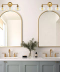 22 Inch Modern Three Light Vanity Bathroom Light With Clear Glass Globe Shades And Warm Brass Finish For Rustic Farmhouse Vibe And A Sharp Stylish Powder Room Glow