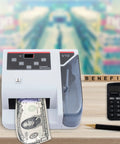 Fast Money Counter With LCD Display And Counterfeit Detection, UV MG IR Authentication on desk with calculator