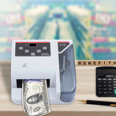 Fast Money Counter With LCD Display And Counterfeit Detection, UV MG IR Authentication on desk with calculator