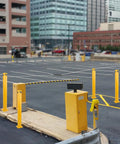 Heavy Duty Steel Safety Bollards Industrial Yellow Powder Coat Includes Anchor Bolts Rock Solid Driveway Guard Post in a parking area.