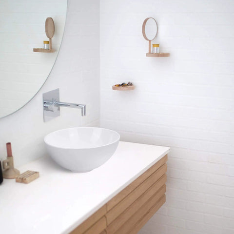 Compact 12 Inch Round Porcelain Vessel Sink With Pop Up Drain For Above Counter Vanity in modern white bathroom setting