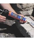 Applying Outdoor Concrete Crack Filler and Waterproof Sealant with caulking gun to concrete surface, gray 10.5 Fl Oz tube.