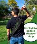 Back archery quiver holder worn with adjustable strap and belt clip, ideal for bow hunting, padded shoulder strap visible