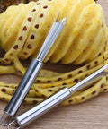 Pineapple Eye Remover And Core Cutter Tool V Shaped Stainless Steel Kitchen Gadget next to peeled pineapple.
