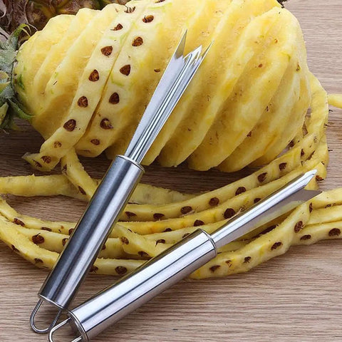 Pineapple Eye Remover And Core Cutter Tool V Shaped Stainless Steel Kitchen Gadget next to peeled pineapple.
