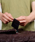 Person applying Tenacious Tape Repair Patches Peel And Stick Nylon Gear Patches for Jackets Tents Sleeping Bags Backpacks and Outdoor Gear